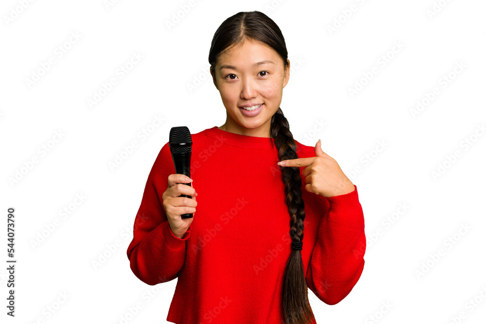 Naklejka premium Young Chinese singer woman isolated person pointing by hand to a shirt copy space, proud and confident
