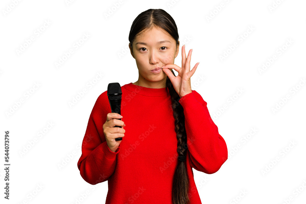 Young Chinese singer woman isolated with fingers on lips keeping a secret. Young Chinese singer woman isolated with fingers on lips keeping a secret.