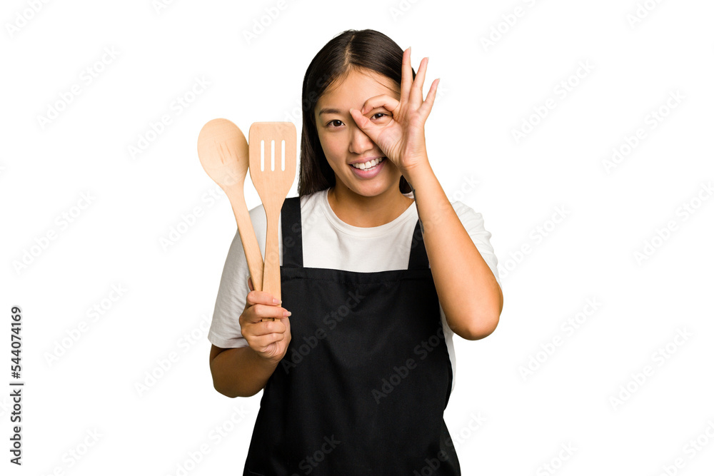 Young asian cook woman isolated excited keeping ok gesture on eye. Young asian cook woman isolated excited keeping ok gesture on eye.