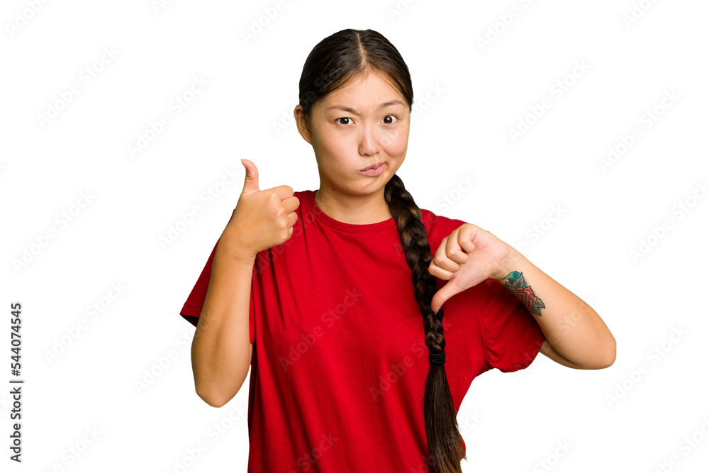 Young Asian woman isolated showing thumbs up and thumbs down, difficult choose concept Young Asian woman isolated showing thumbs up and thumbs down, difficult choose concept