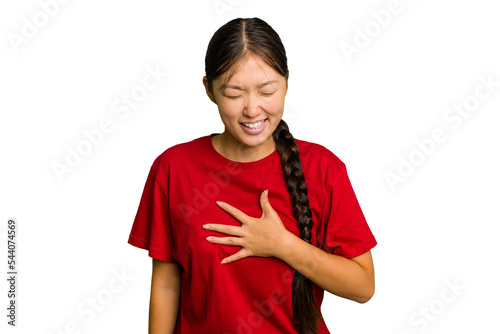 Young Asian woman isolated laughs out loudly keeping hand on chest.