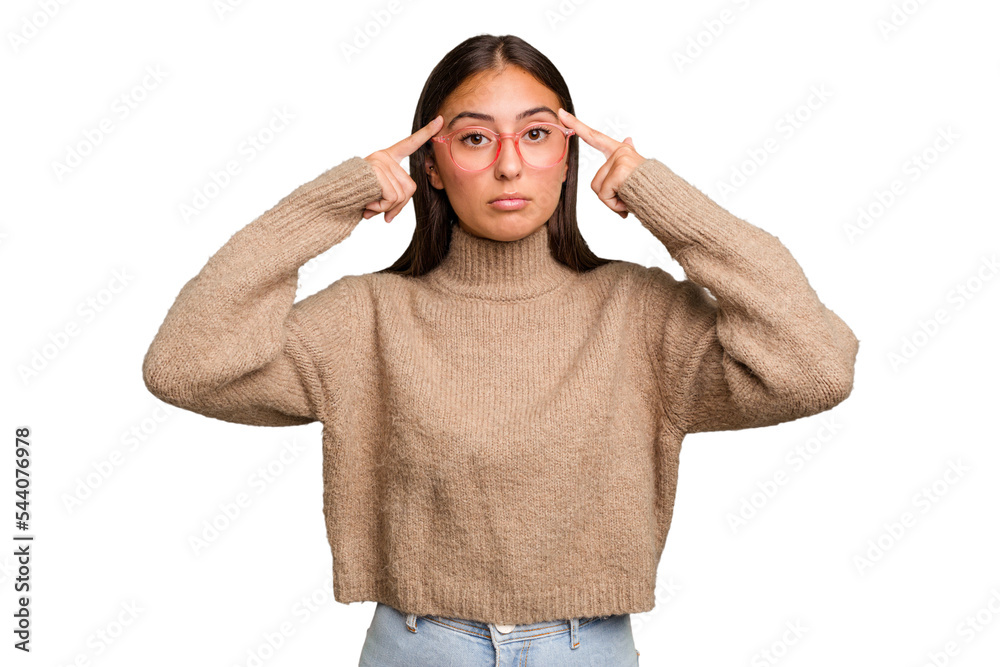 Young cute caucasian woman isolated focused on a task, keeping forefingers pointing head. Young cute caucasian woman isolated focused on a task, keeping forefingers pointing head.