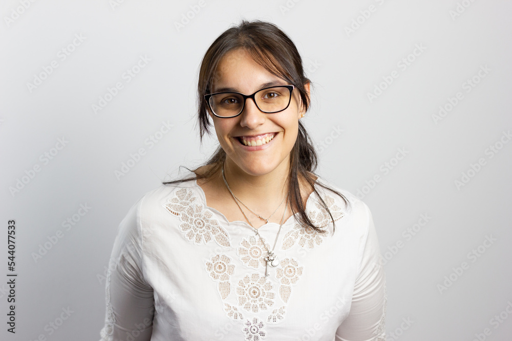 Woman on white background smiling looks at the camera Woman on white background smiling looks at the camera
