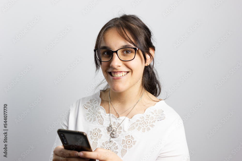Woman on white background smiling looks at the camera