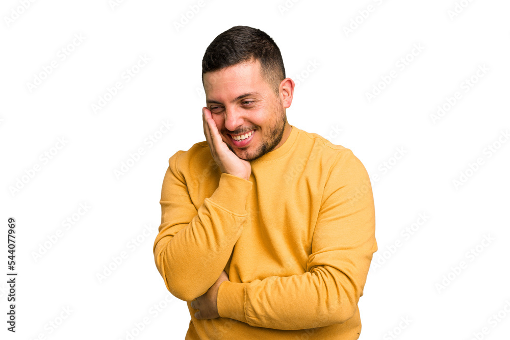 Fototapeta premium Young caucasian man isolated laughs happily and has fun keeping hands on stomach.