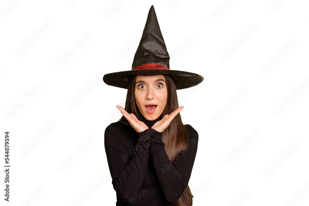 Young caucasian woman dressed as a witch for halloween day isolated surprised and shocked. Young caucasian woman dressed as a witch for halloween day isolated surprised and shocked.