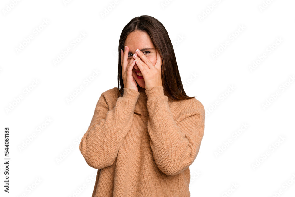 Young caucasian cute woman isolated blink at the camera through fingers, embarrassed covering face. Young caucasian cute woman isolated blink at the camera through fingers, embarrassed covering face.