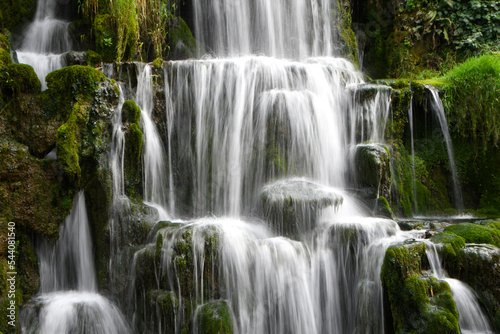 A cascade of waterfalls showing the flow of water falling down over rocks © PeteG