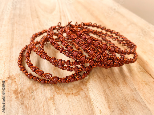 handmade bracelet made by wire copper with brown beads.