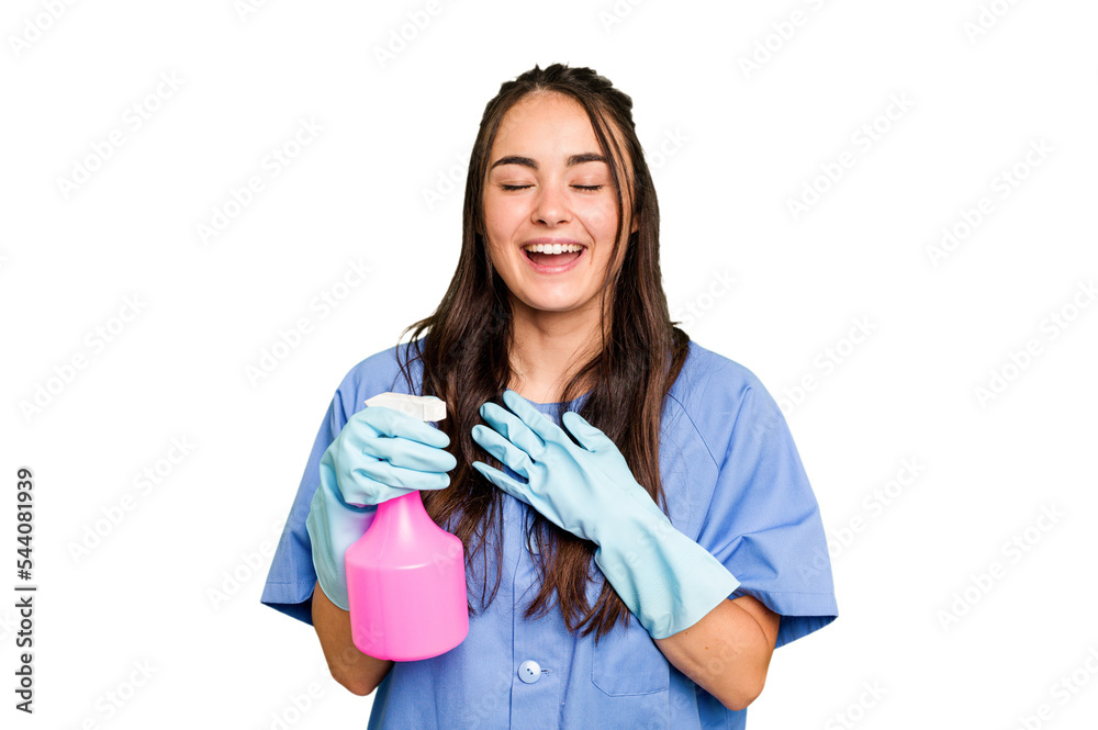 Young cleaner caucasian woman isolated on green chroma background laughs out loudly keeping hand on chest. Young cleaner caucasian woman isolated on green chroma background laughs out loudly keeping hand on chest.