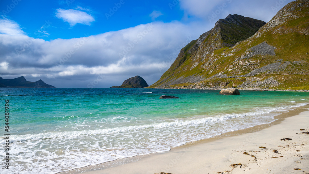 paradise beach amidst the mighty norwegian cliffs, famous haukland beach in the lofoten islands, norway; beach in the norwegian fjord