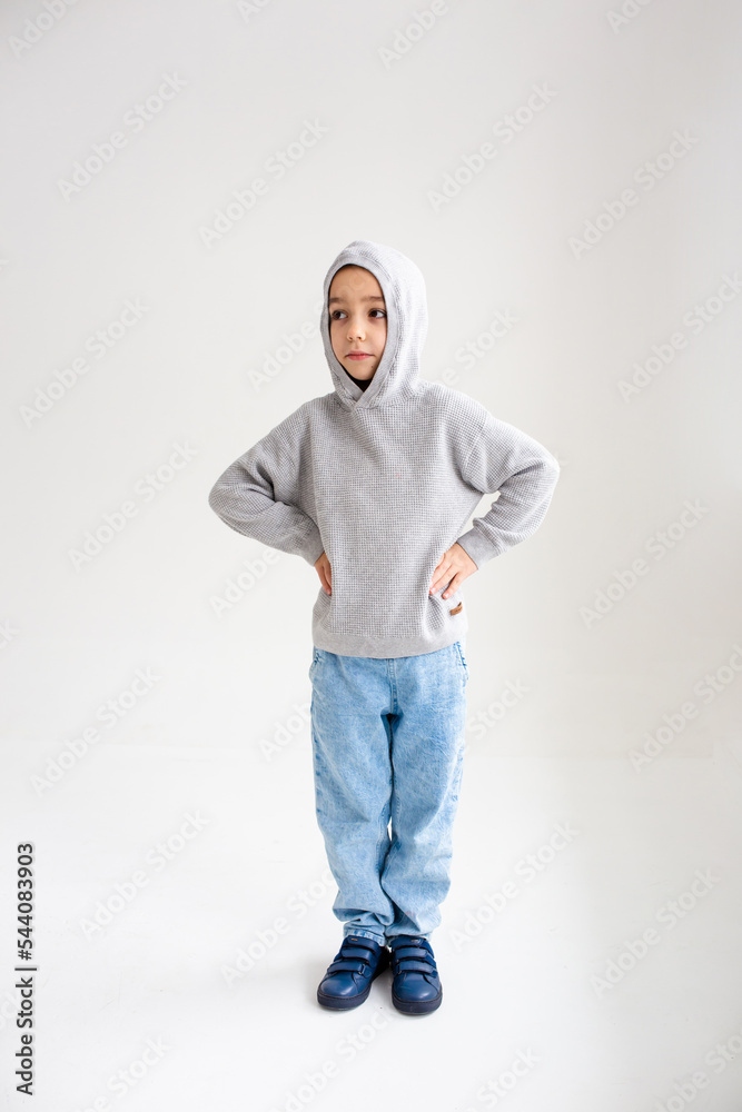 Fototapeta premium Boy child preschooler smiling and posing on gray background in photo studio