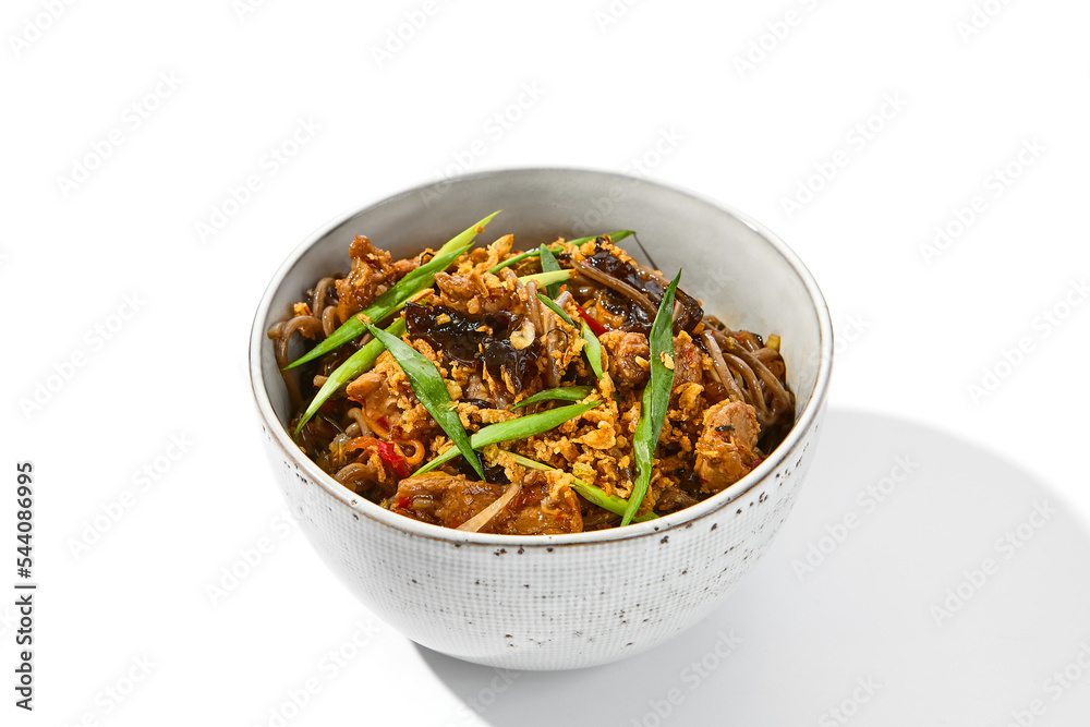 Asian fried buckwheat noodles with beef and vegetables isolated on white background. Japanese fried noodles teriyaki in ceramic bowl. Fried on wok soba with beef in minimal style. Wok menu. Asian fried buckwheat noodles with beef and vegetables isolated on white background. Japanese fried noodles teriyaki in ceramic bowl. Fried on wok soba with beef in minimal style. Wok menu.