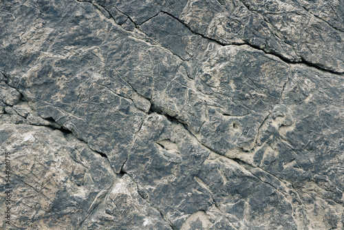 Texture of dark stone surface with cracks. photo