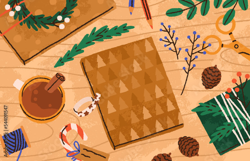 Christmas gift box in kraft paper wrapping with DIY decorations on wood table...