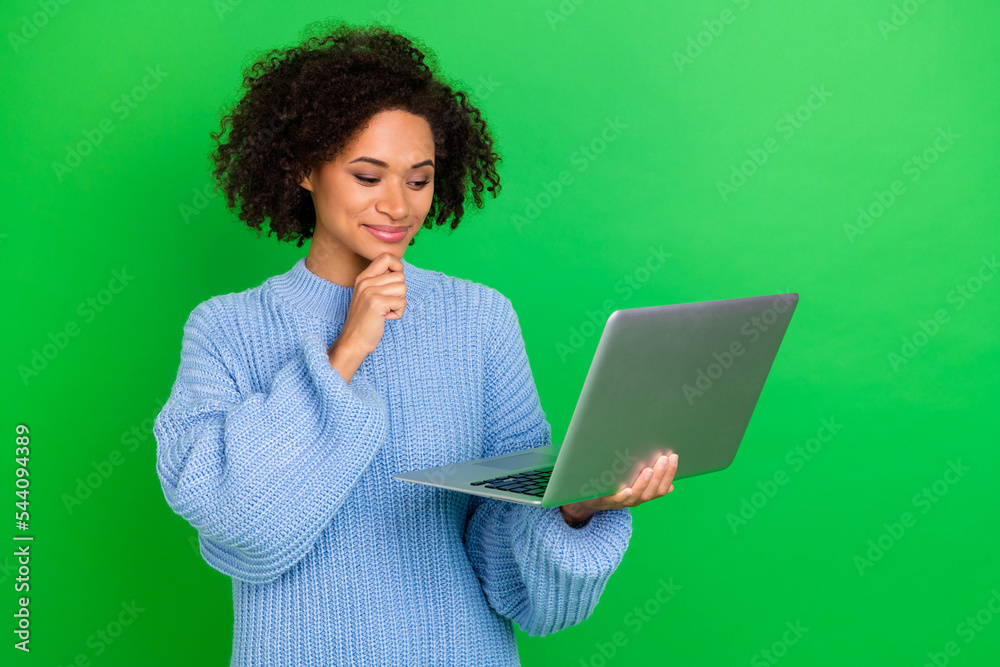 Photo of creative minded person hand touch chin use netbook isolated on green color background Photo of creative minded person hand touch chin use netbook isolated on green color background