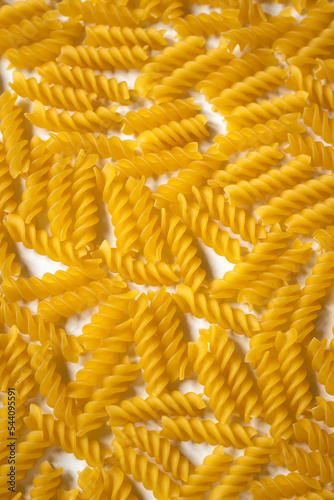Vertical close up photo of fusilli - Italian durum wheat dry pasta
