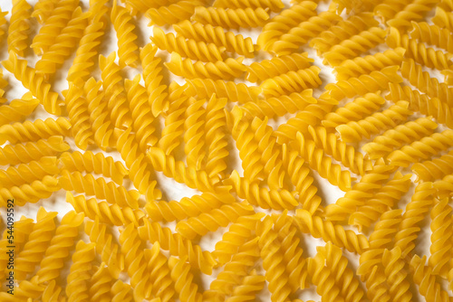 Horizontal close up photo of fusilli - Italian durum wheat dry pasta