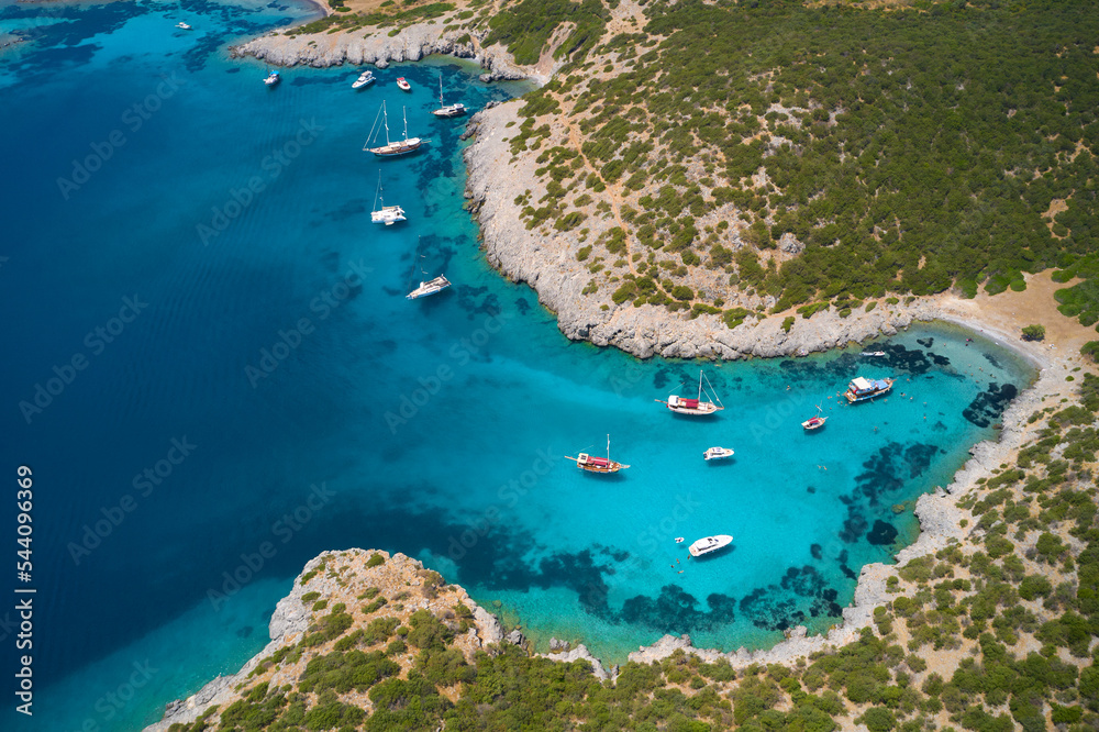 Aerial view of blue sea lagoon and yachts along the mediterranean coast. Landscape of turkish riviera nature - obrazy, fototapety, plakaty 