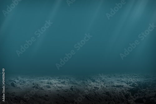 Dark blue ocean seen from underwater. Dead seabed of stones and rocks