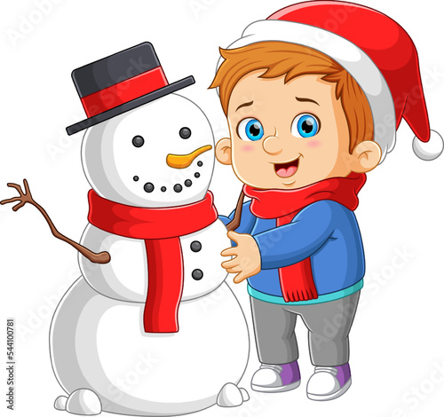 The boy is making the big snowman and playing with the snowball