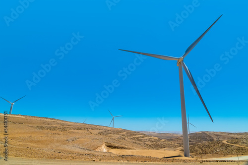 A view of wind turbines above the gorge at Little Petra, Jordan in summertime photo