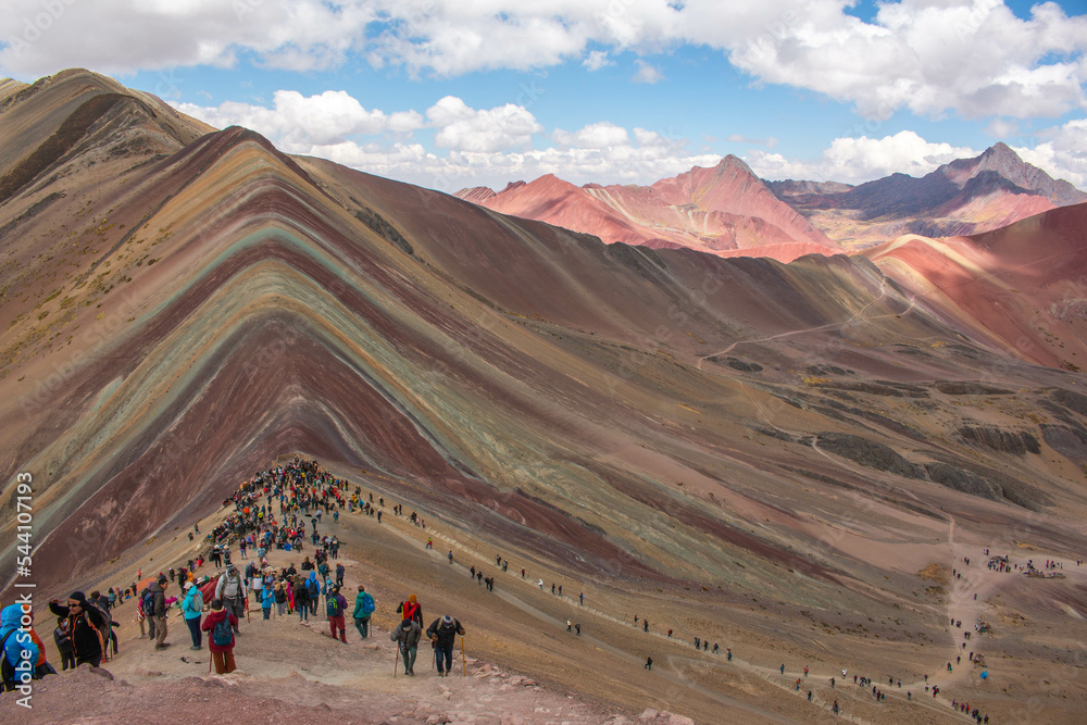 Crowds of people on Rainbow Mountain, Peru. With view of the mountain and the valley. Crowds of people on Rainbow Mountain, Peru. With view of the mountain and the valley.