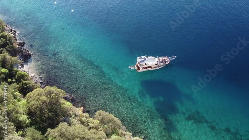 Aerial view of beautiful yacht at scenic sea bay with rocks  photo