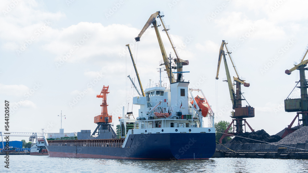 Vessel on which coal is loaded at the seaport. Port cranes for loading coal onto ship, Kaliningrad, Russia