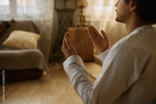 Stampa su tela Close up of Muslim believer during prayer at home.