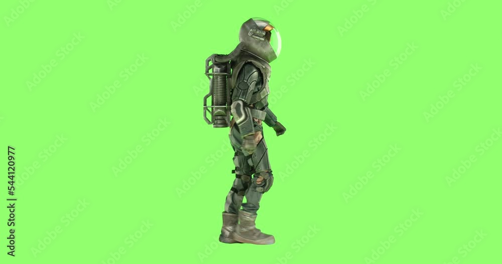 CHROMA KEY Side view of male astronaut wearing a spacesuit walking against green screen