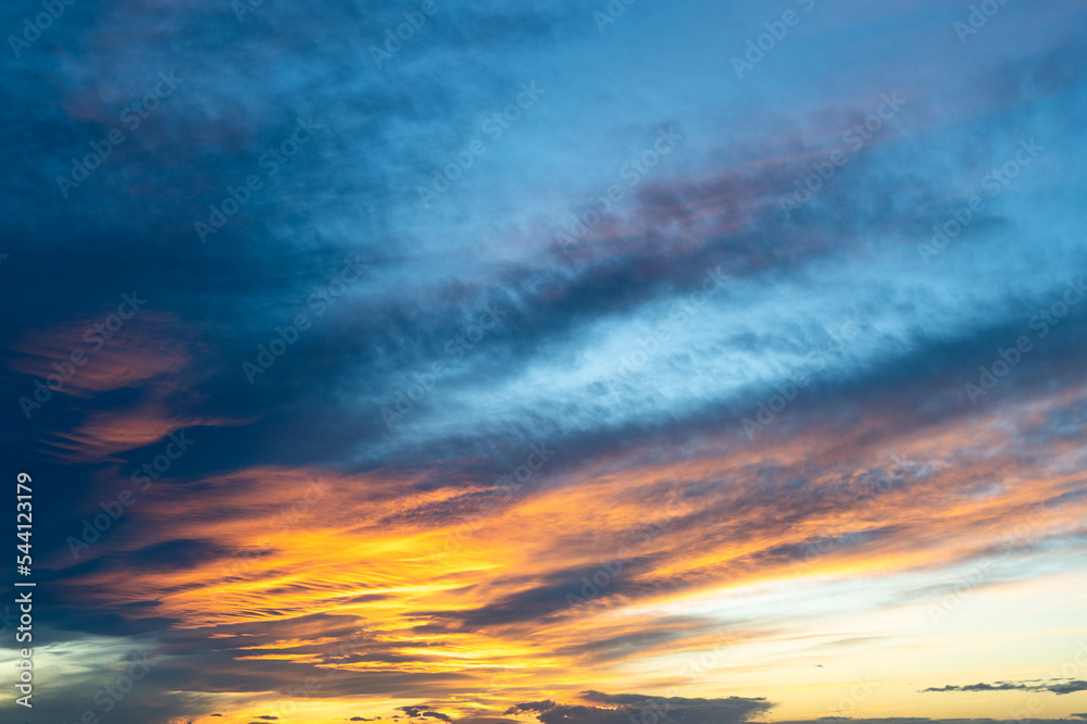 Cloudscape at sunset time with golden clouds and blue sky Cloudscape at sunset time with golden clouds and blue sky