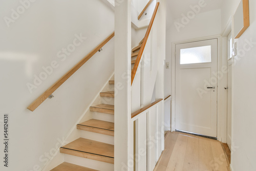 Light hallway with white staircase