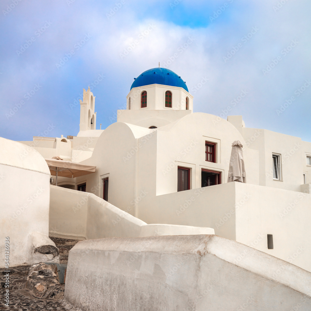 Santorini, Greece. Conceptual composition of the famous architecture of the island of Santorini. White church with a blue dome. Santorini island, Greece, Europe. Santorini, Greece. Conceptual composition of the famous architecture of the island of Santorini. White church with a blue dome. Santorini island, Greece, Europe.