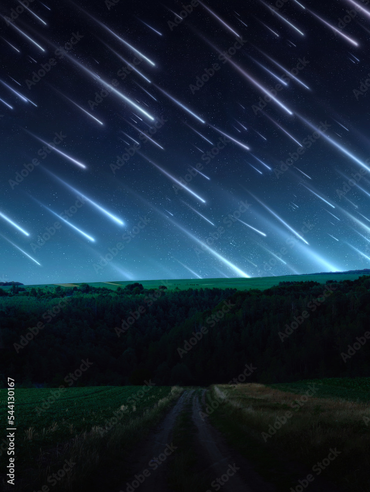 Meteor shower over the hills. Bright stream of meteors in the night sky