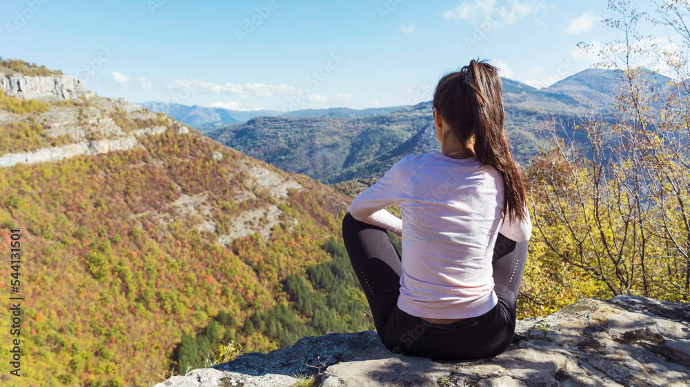 Woman sitting high  in the autumn  mountain with stunning panoramic  view . Balkan mountains,  ,Bulgaria