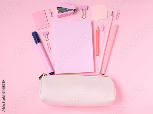 Fotografia School and office supplies with pencil case on pink background, monochrome conce