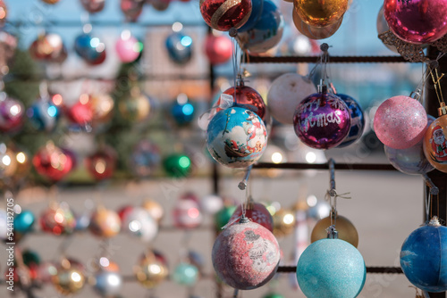 Various colorful Christmas balls with blurred baubles background, selective focus