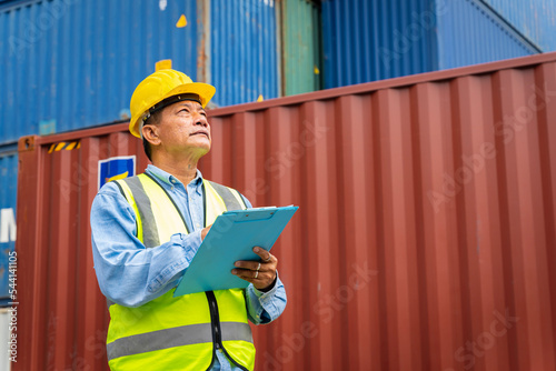 male engineers in a container shipping company Consulting to check the order for the container that is responsible