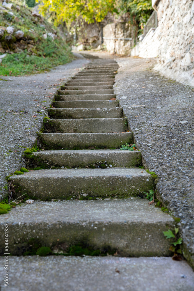 Step by step to top. Stone narrow stairway up direction, Peloponnese forest, Greece. Vertical Step by step to top. Stone narrow stairway up direction, Peloponnese forest, Greece. Vertical