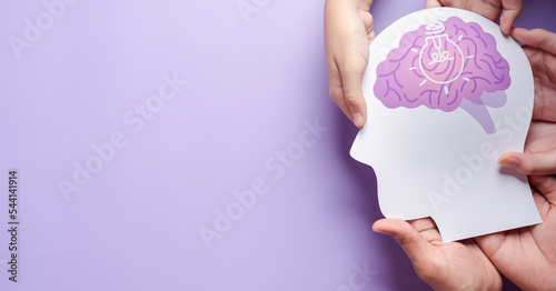 hands holding brain with light bulb paper cut, innovation idea creative, autism, Stroke, Epilepsy and alzheimer awareness, seizure disorder, stroke, ADHD, world mental health day