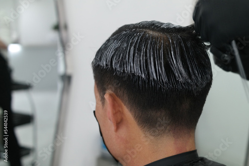 Back view of a man applying perm