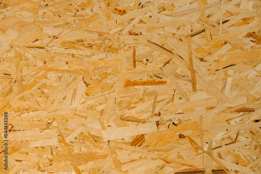 Close up pressed wooden panel background, texture of oriented strand board - OSB wood Close up pressed wooden panel background, texture of oriented strand board - OSB wood