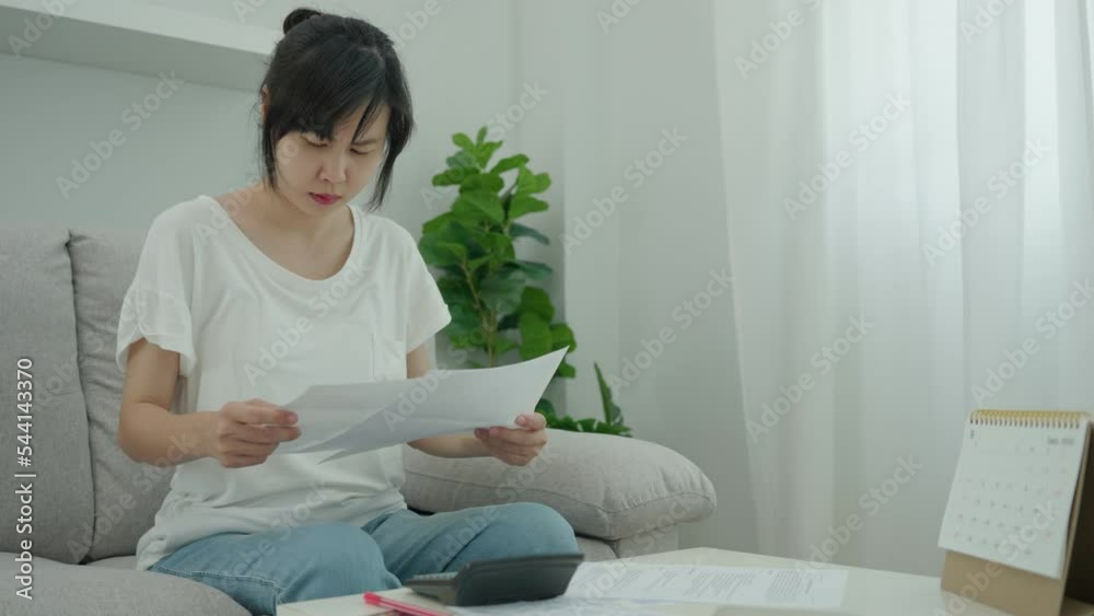 women calculate invoice on monthly. Asian women are stressed about debt problems an financial problem. financial problems and Debt concepts women calculate invoice on monthly. Asian women are stressed about debt problems an financial problem. financial problems and Debt concepts