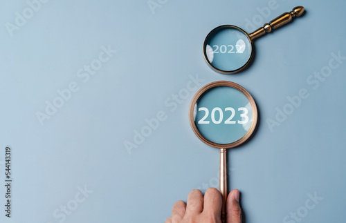 Target business on 2023 year concept. Magnifier focus to 2023 icon. planning project, invest, innovation, idea to next year from end 2022, New year concept.