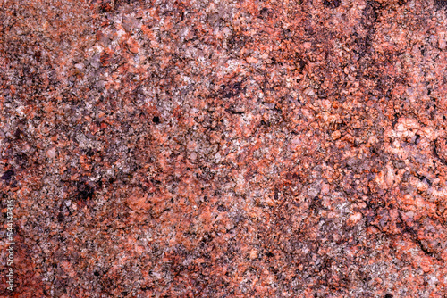 Red granite rock close up background photo