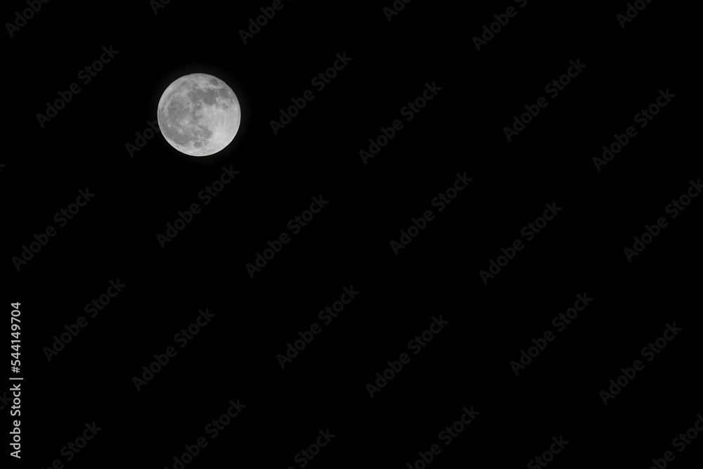 Full moon on a dark sky with copy space. Blue moon on October 31, 2020. Space for text. Full moon on a dark sky with copy space. Blue moon on October 31, 2020. Space for text.