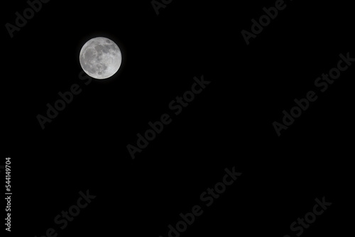 Fototapeta Full moon on a dark sky with copy space