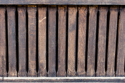 Old wood fence with detailed surface of a rustic home and distanced planks