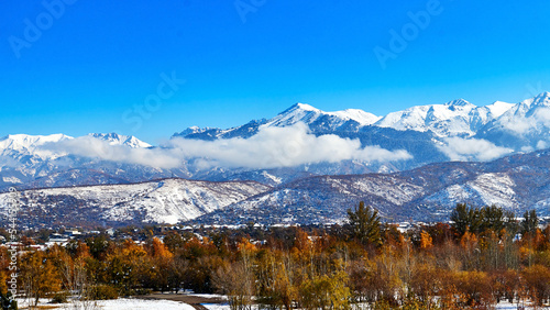 panoramic view of snow-capped mountains with clouds
